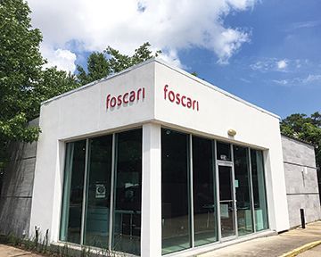 A white building with a red sign on the side of it.