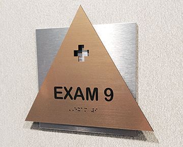 A sign on a wall that says exam 9