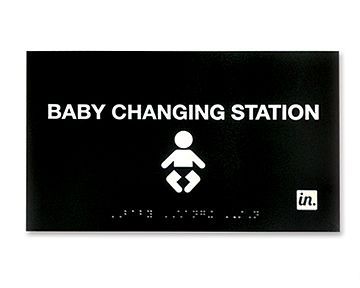 A black sign that says baby changing station on it