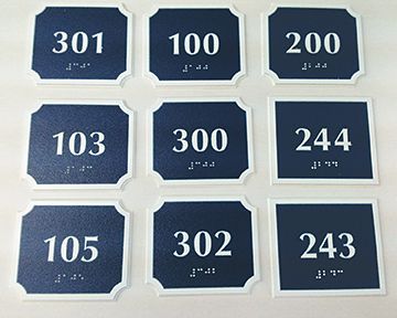 A set of blue signs with the numbers 301 to 243