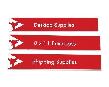 Three red signs that say desktop supplies , 8 x 11 envelopes , and shipping supplies.