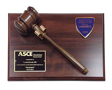 A wooden plaque with a gavel and a plaque that says asce