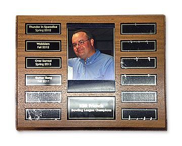 A wooden plaque with a picture of a man on it