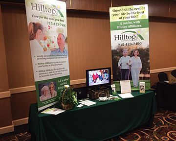 A table with a sign on it that says `` hilltop care for the ones you love ''.