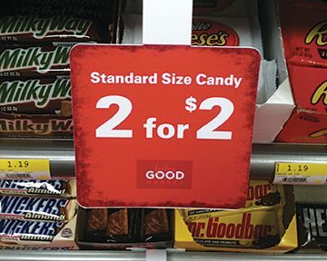 A sign that says standard size candy 2 for 2