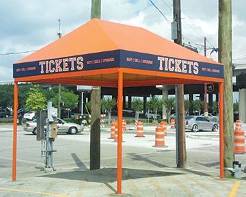 An orange and blue tent that says tickets on it