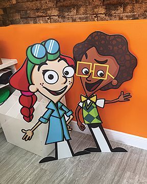 A couple of cardboard cutouts of cartoon characters standing next to each other.