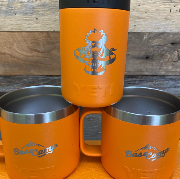 Three orange Yeti mugs are stacked on top of each other.