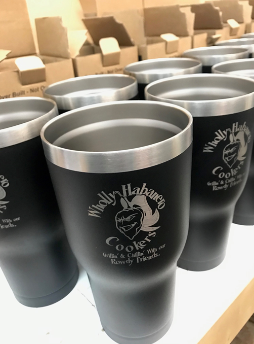 A bunch of stainless steel tumblers with a logo on them.