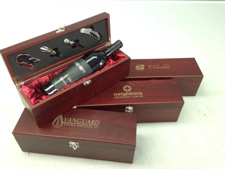 A bottle of wine is in a wooden box that says vanguard.