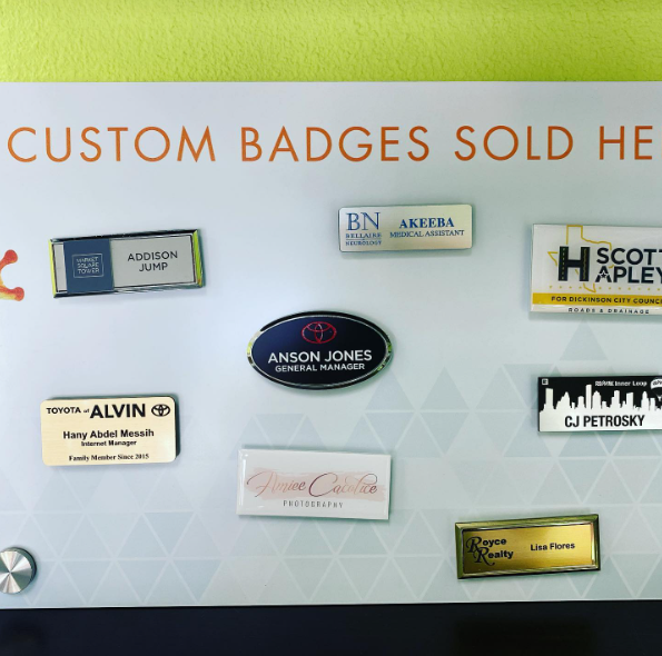 A sign that says custom badges sold here.