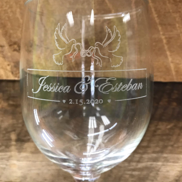 A wine glass with the name Jessica and Esteban engraved on it.
