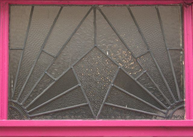 A stained glass window with a pink frame
