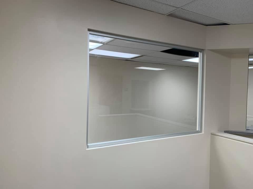 An empty room with a window in the wall.