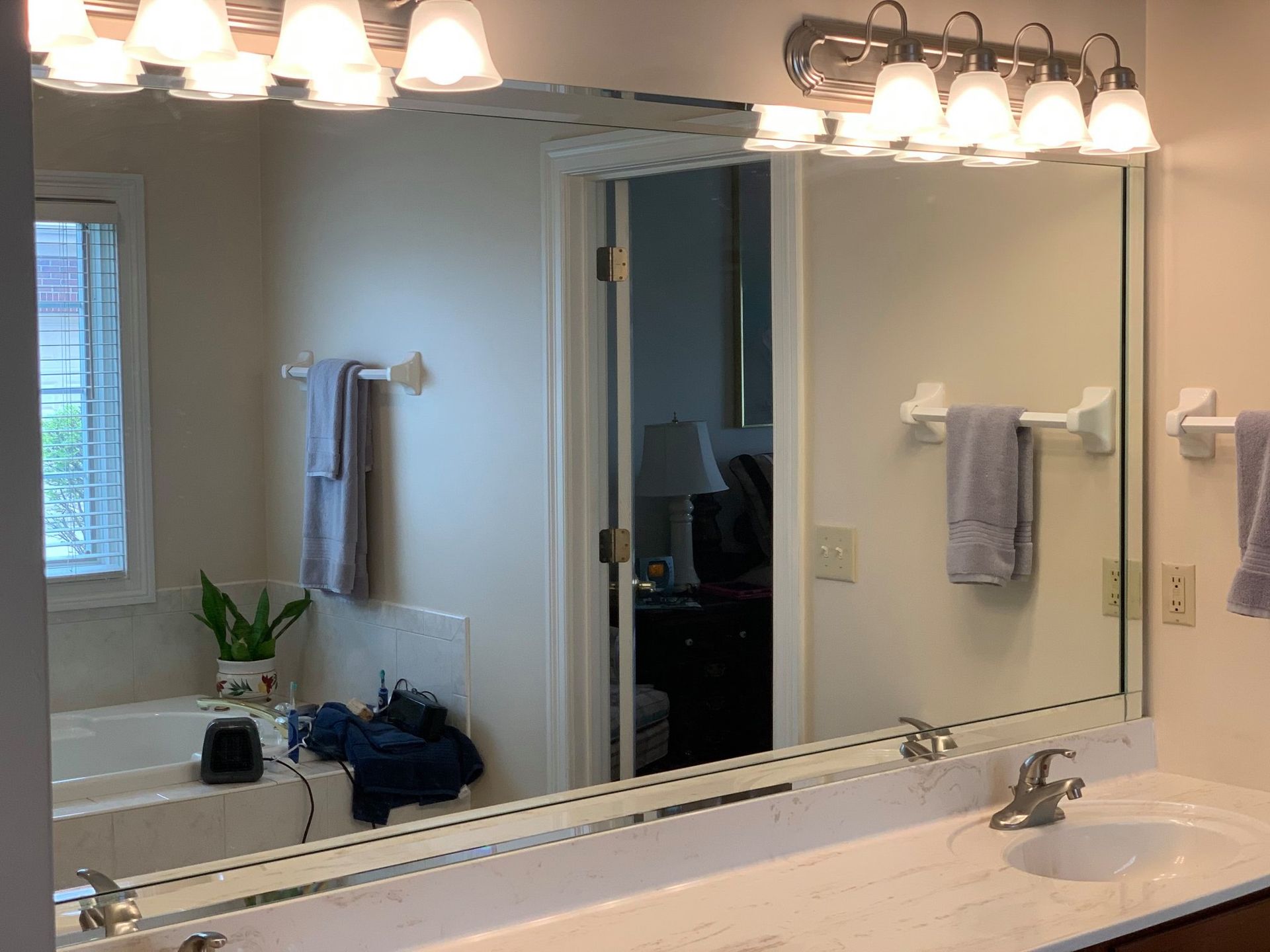 A bathroom with two sinks and a large mirror