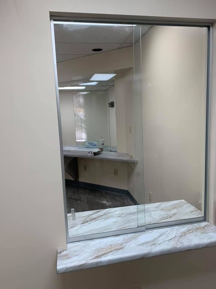 A large mirror is hanging on a wall in a room.