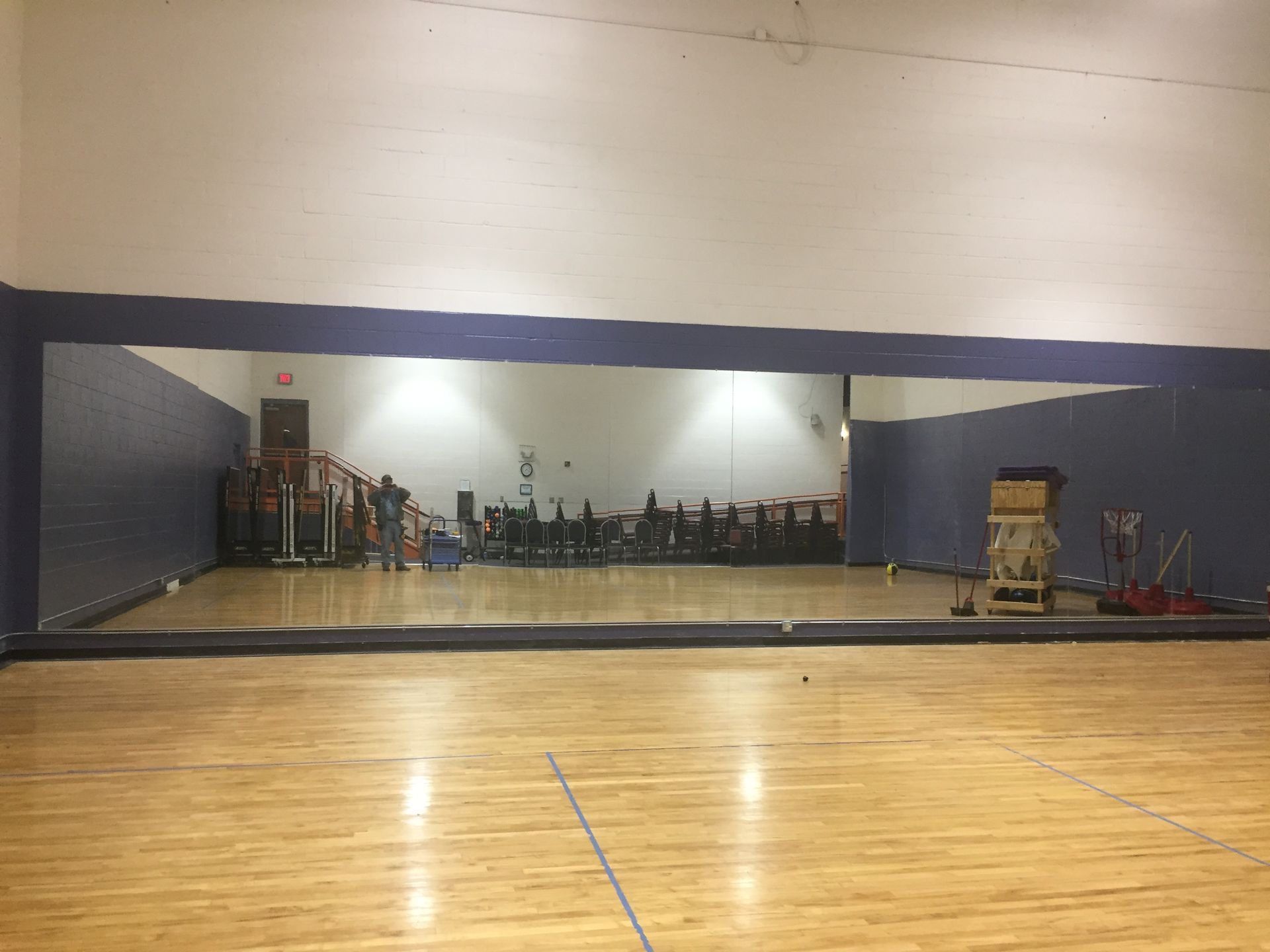 An empty gym with a large mirror on the wall