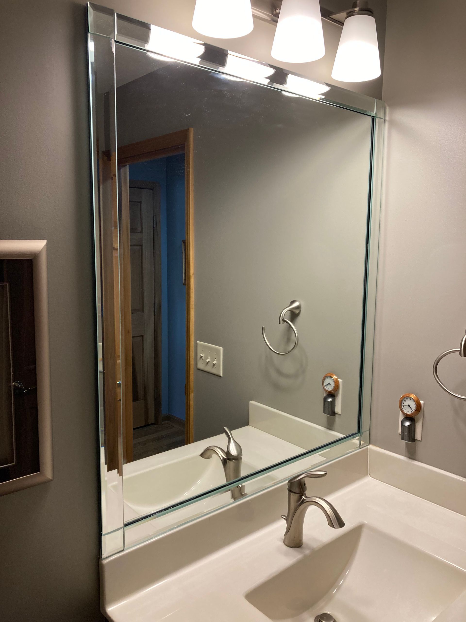 A bathroom sink with a large mirror above it.