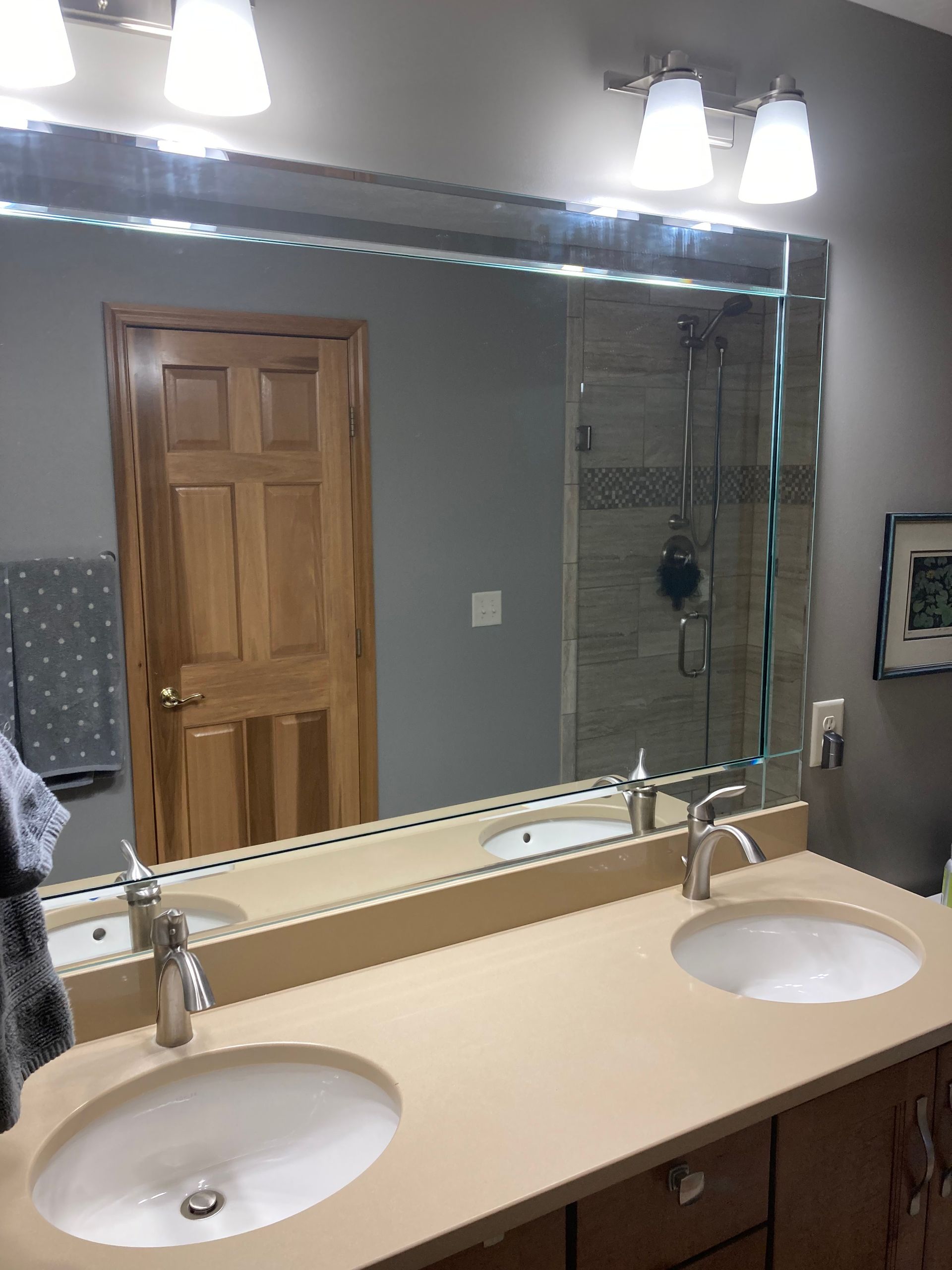 A bathroom with two sinks and a large mirror.