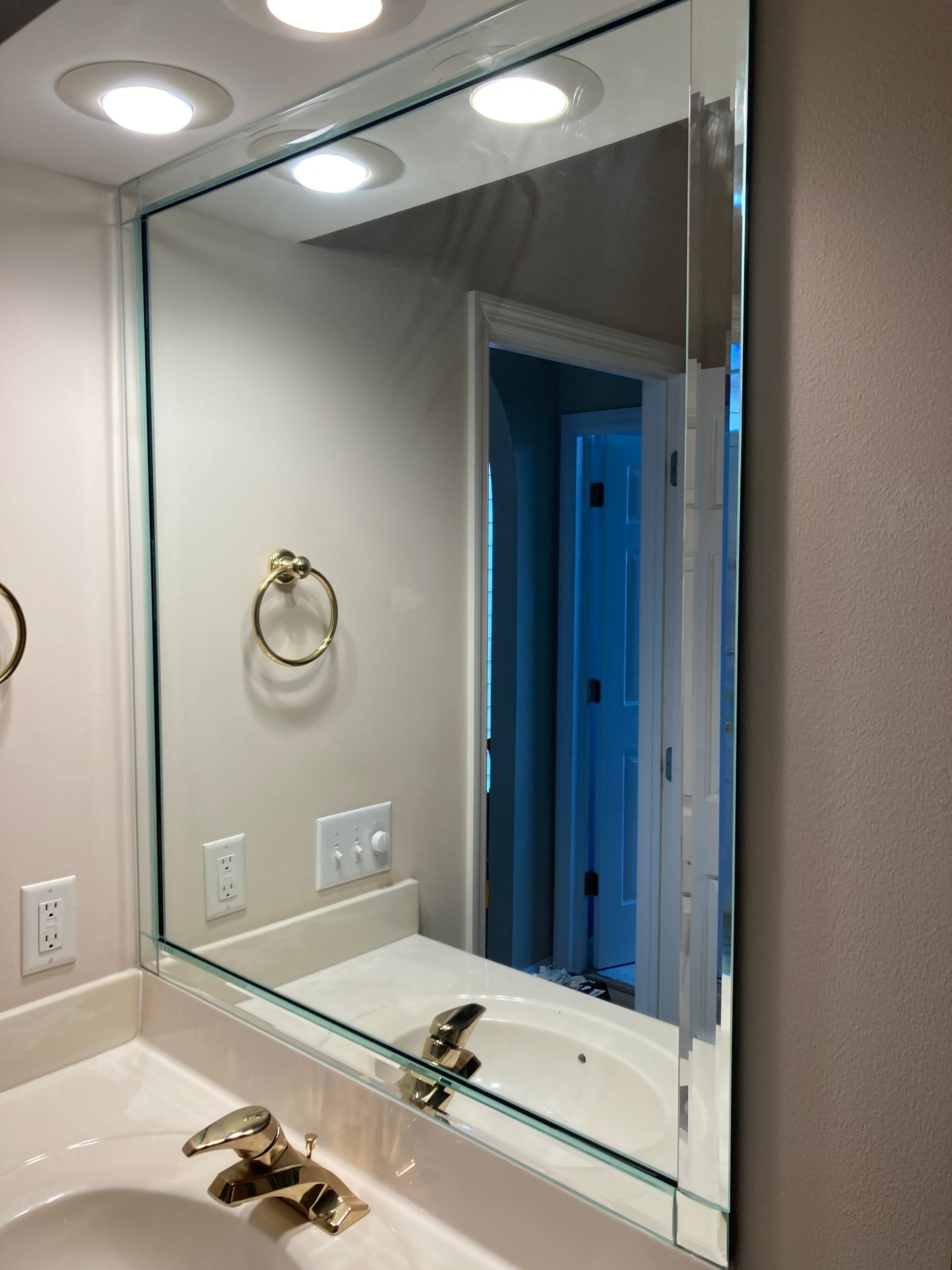 A bathroom sink with a large mirror above it