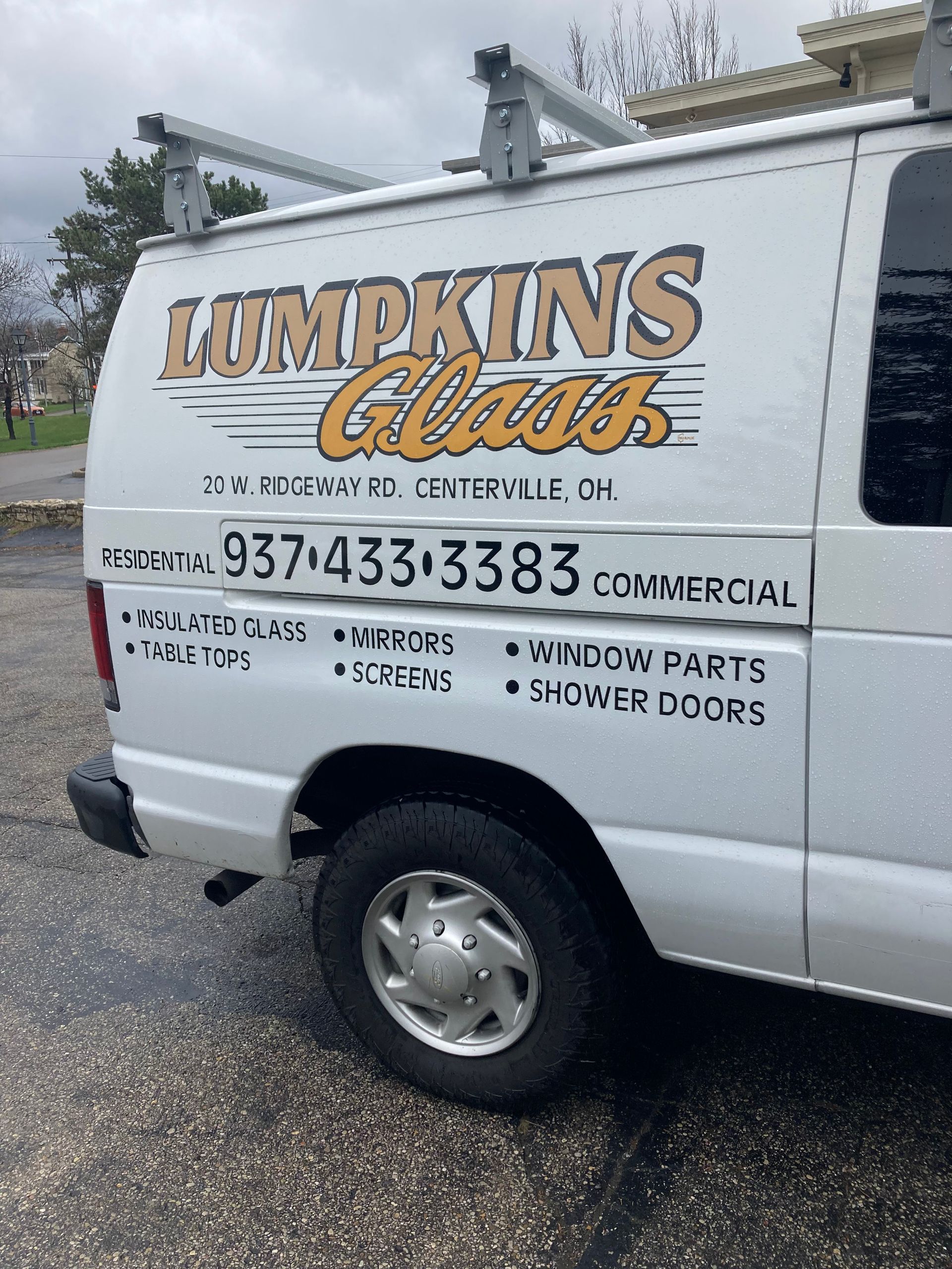 A white van that says lumpkins glass on the side