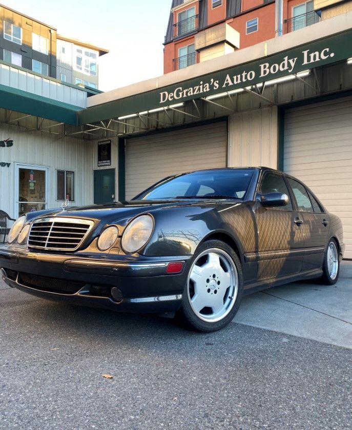 A car is parked in front of Degrazia 's Auto Body Inc