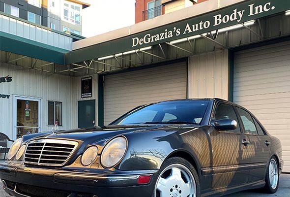 A car is parked in front of Degrazia 's Auto Body Inc