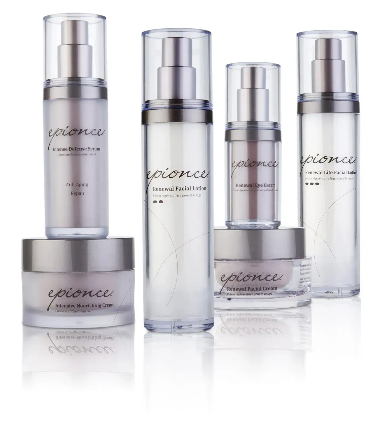 Epionce skincare products displayed on a white background. Silver and clear bottles and jars are arranged in a group.