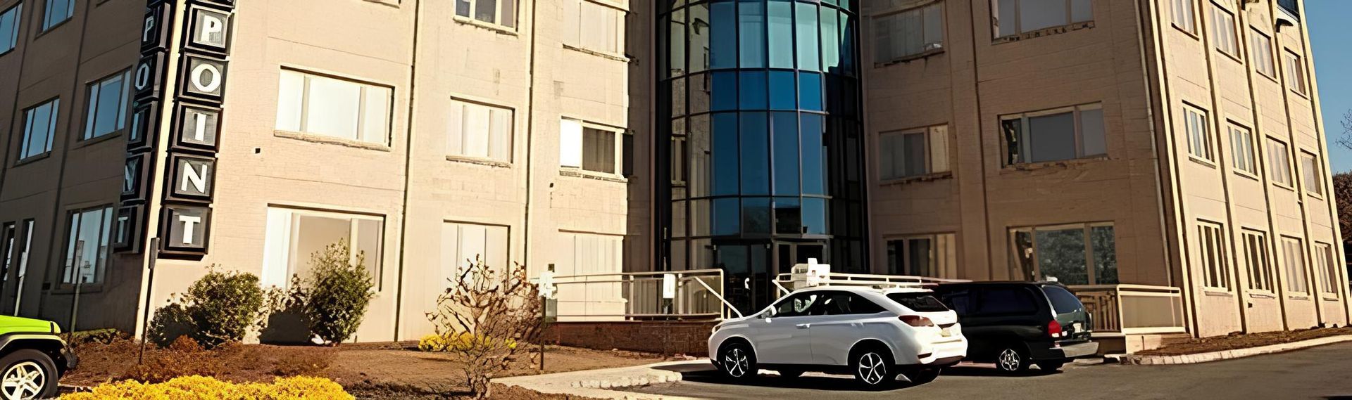 Exterior view of an office building with a sign that says