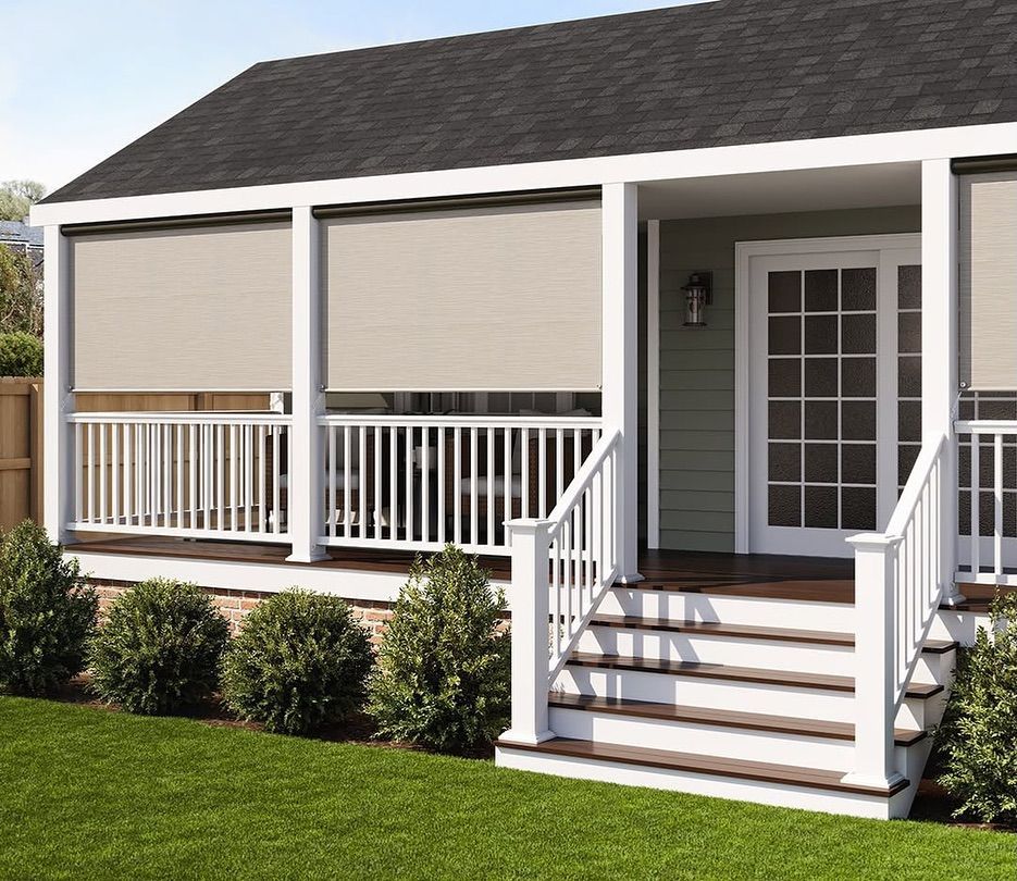 Beige outdoor shades on a white porch, with steps and a green lawn.