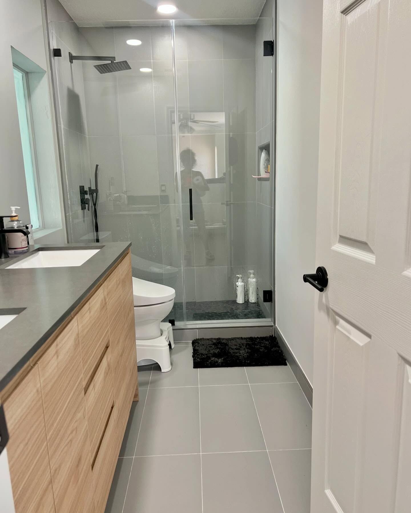 A bathroom with a toilet , sink , and shower.