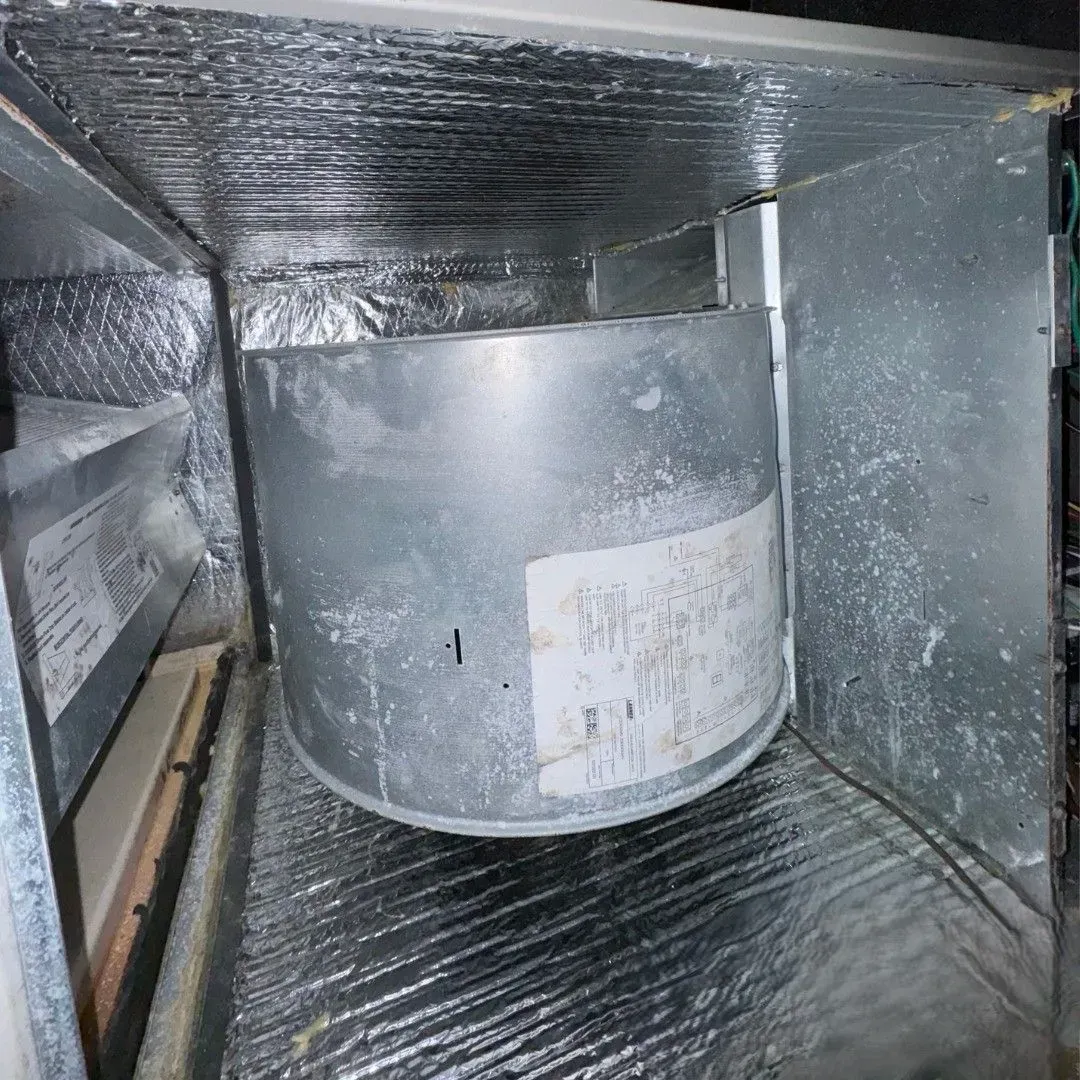 Cylindrical metal duct inside an insulated HVAC vent