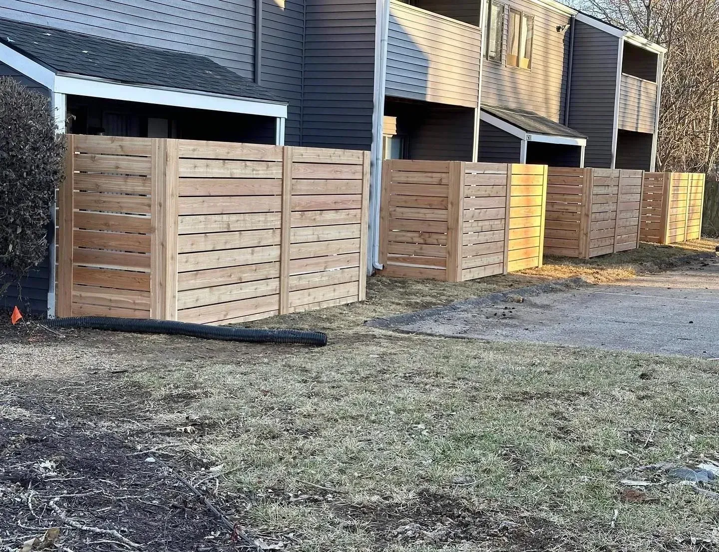 Wooden trash enclosures outside a building.