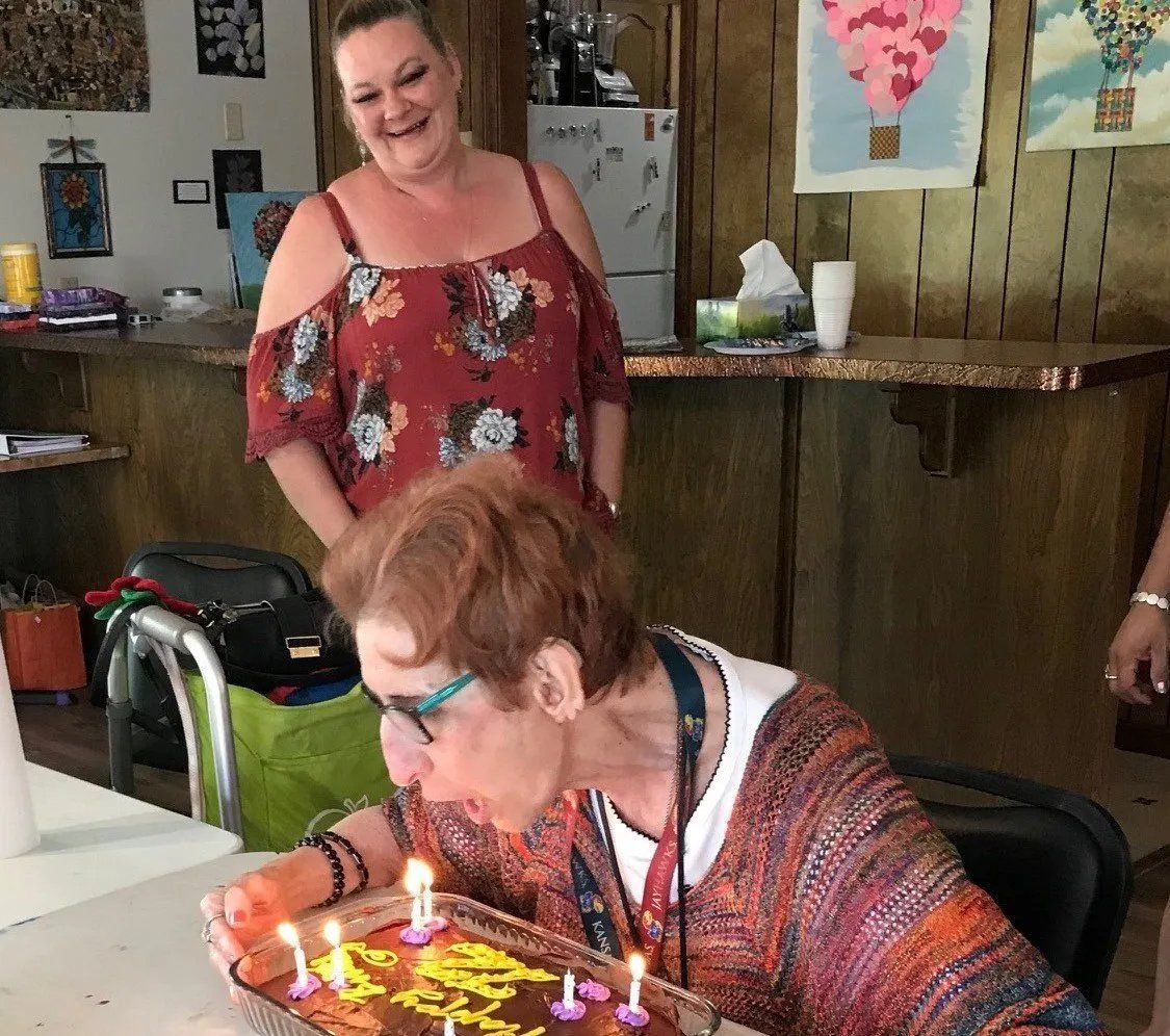Senior blowing cake candle