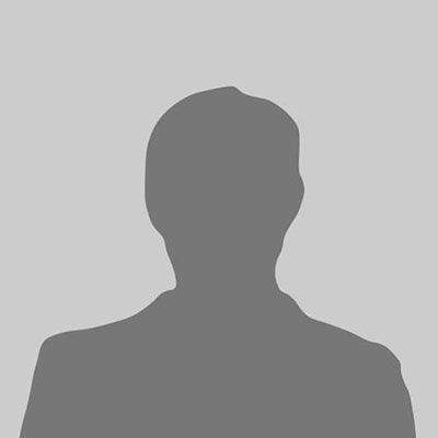 Silhouette of a person with broad shoulders, facing forward against a gray background.