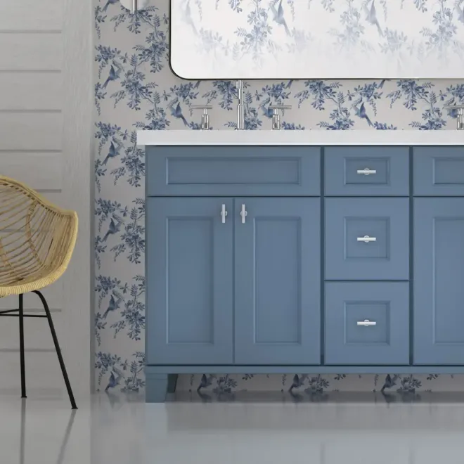 Person installing a cabinet door in a kitchen with wooden cabinets and a tiled backsplash