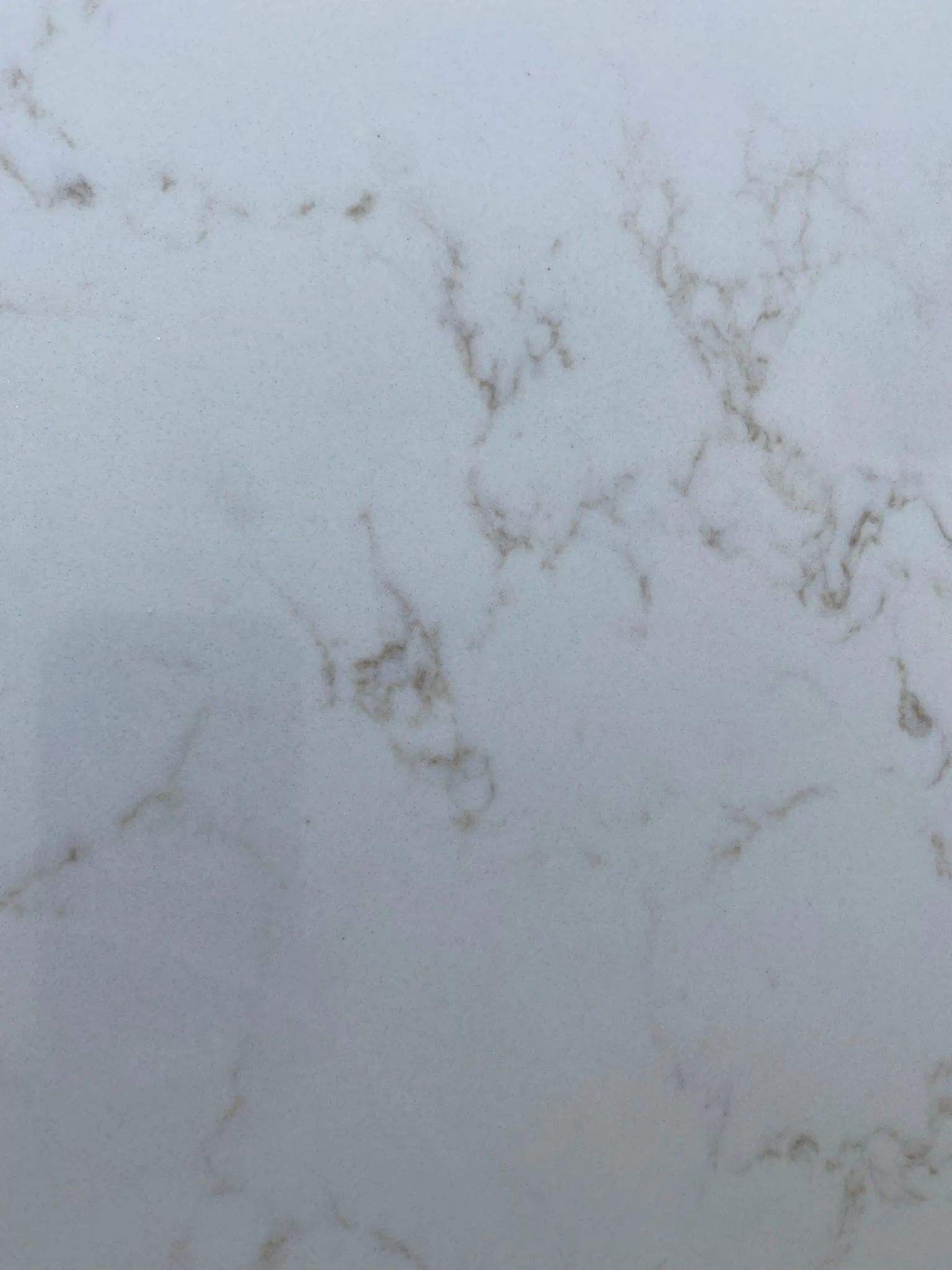Light gray marble surface with faint beige veining