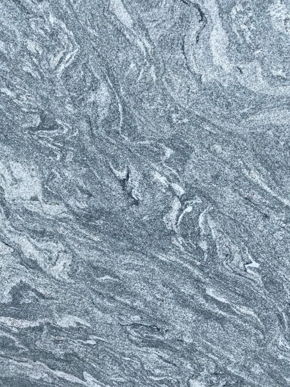 Gray marbled stone texture with swirling white and silver patterns