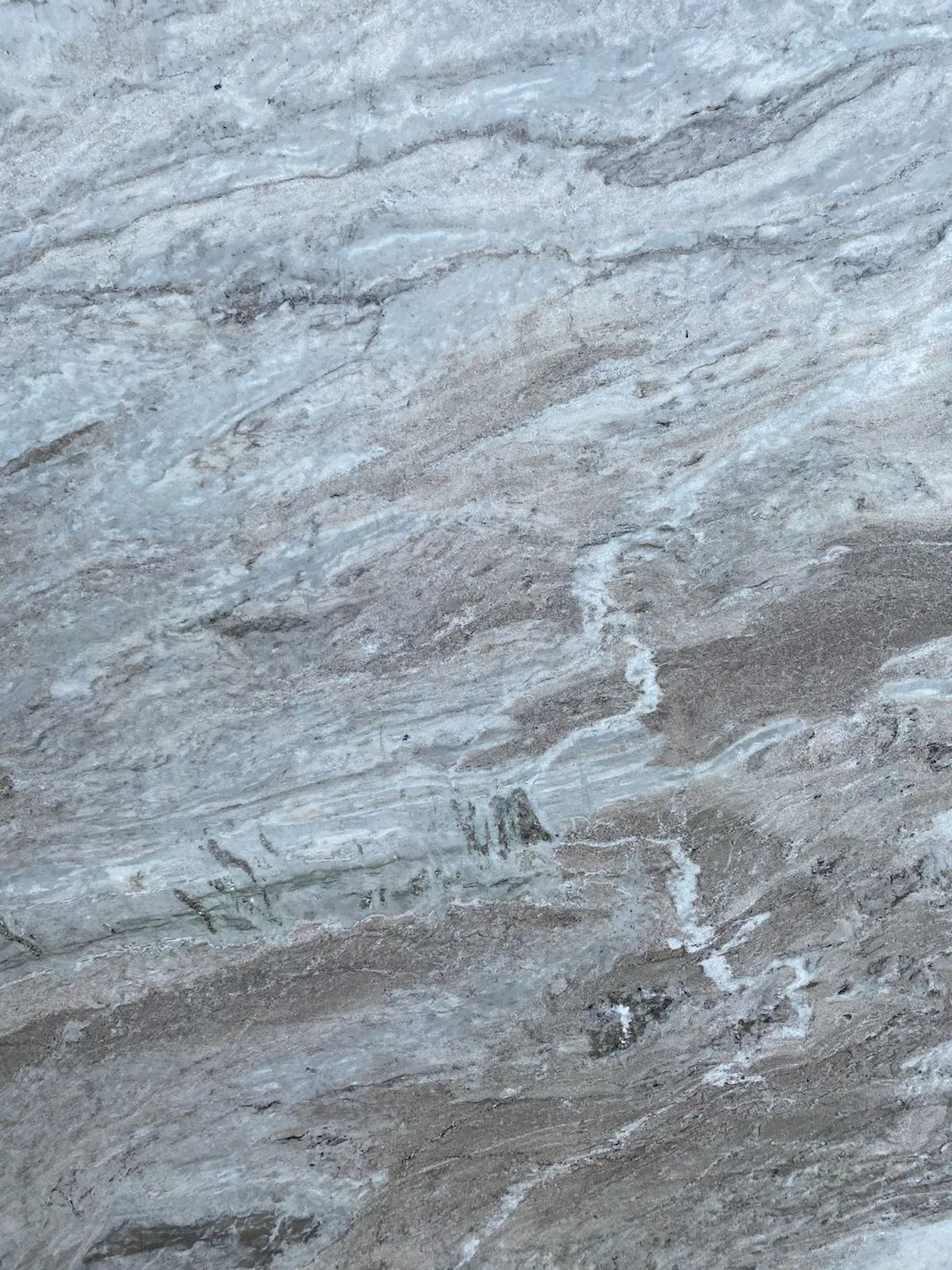 Gray and white marbled stone surface with wavy streaks