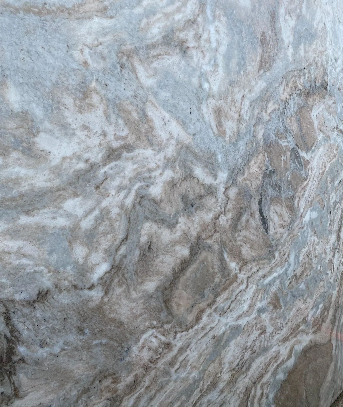 Abstract swirled gray, white, and blue marble-like stone texture