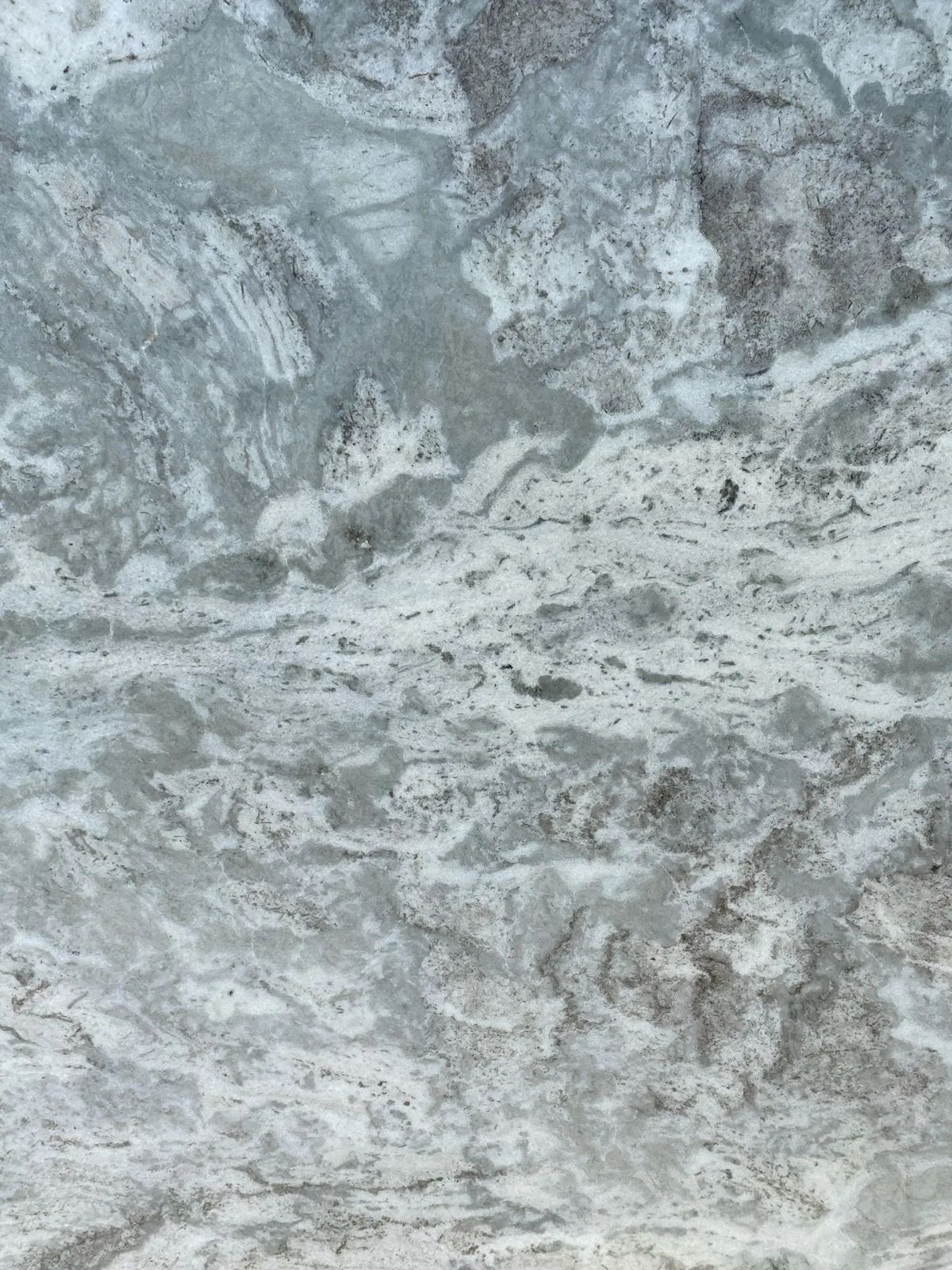 Gray and white marbled stone texture with cloudy, swirling patterns