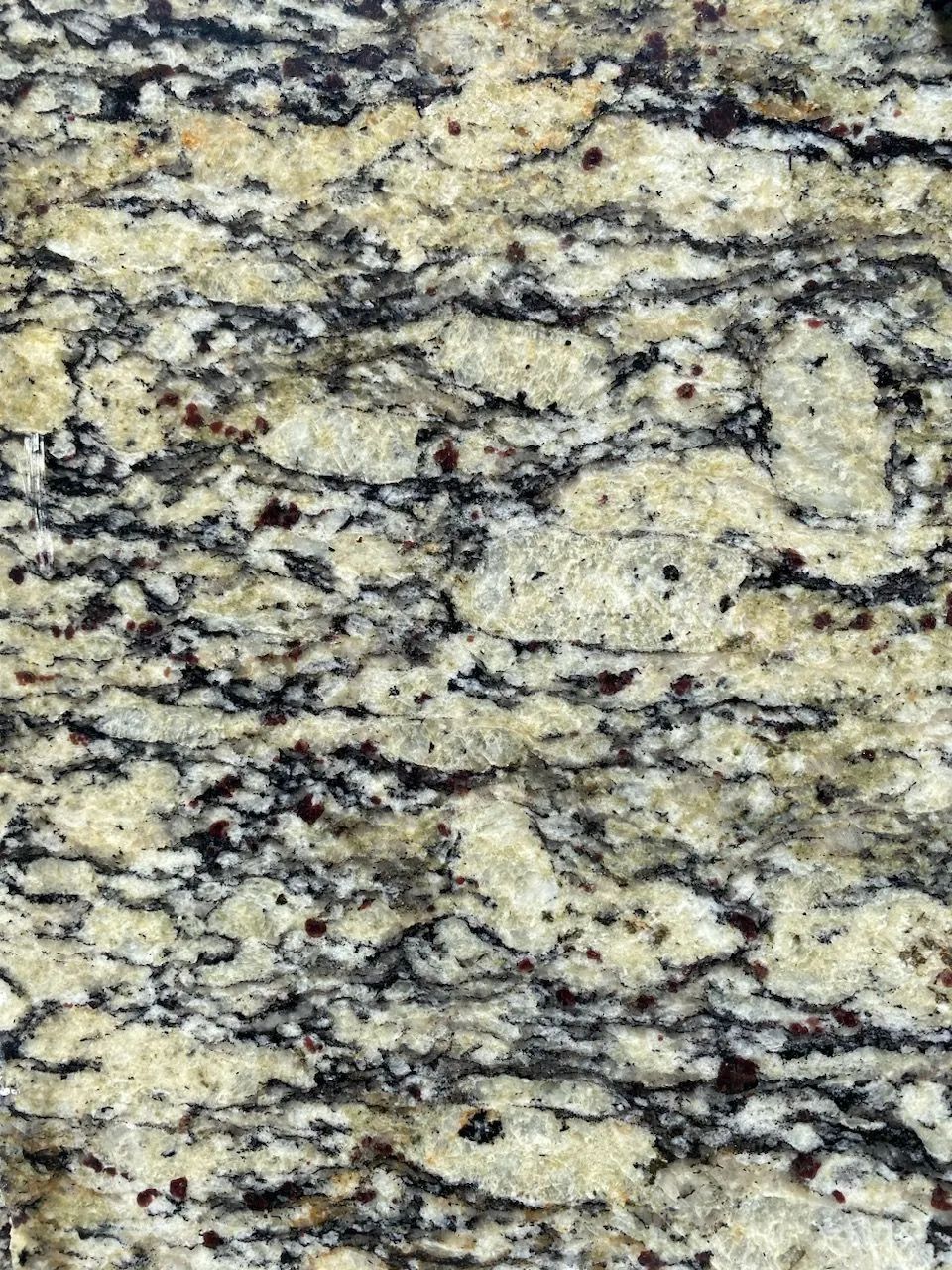 Mottled beige, black, and gray granite countertop surface