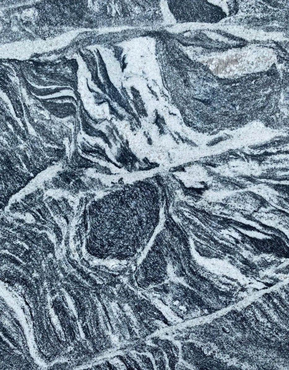 Abstract gray and white marbled texture with swirling vein-like patterns
