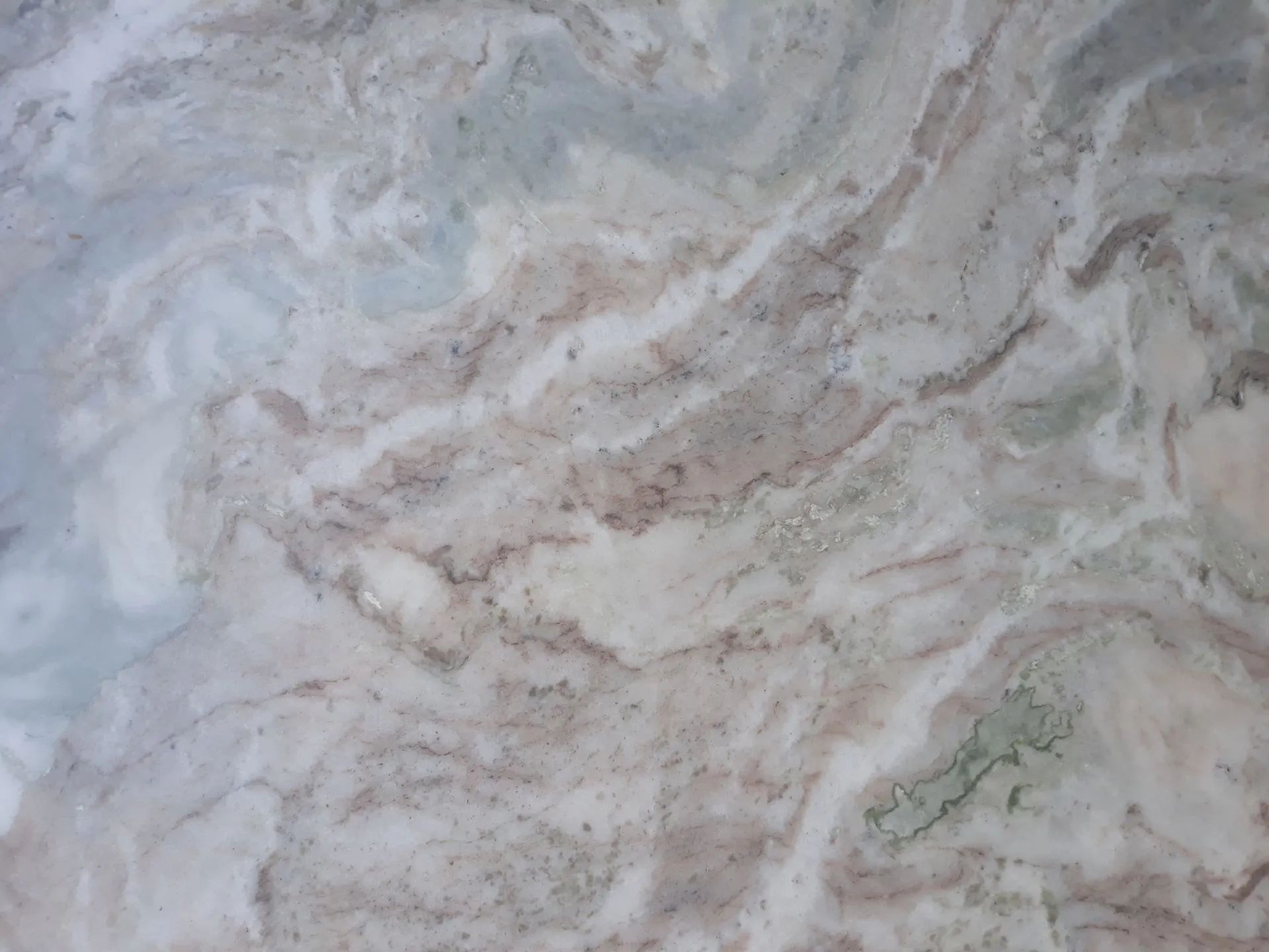 Abstract gray and beige marble-like stone texture with swirling patterns