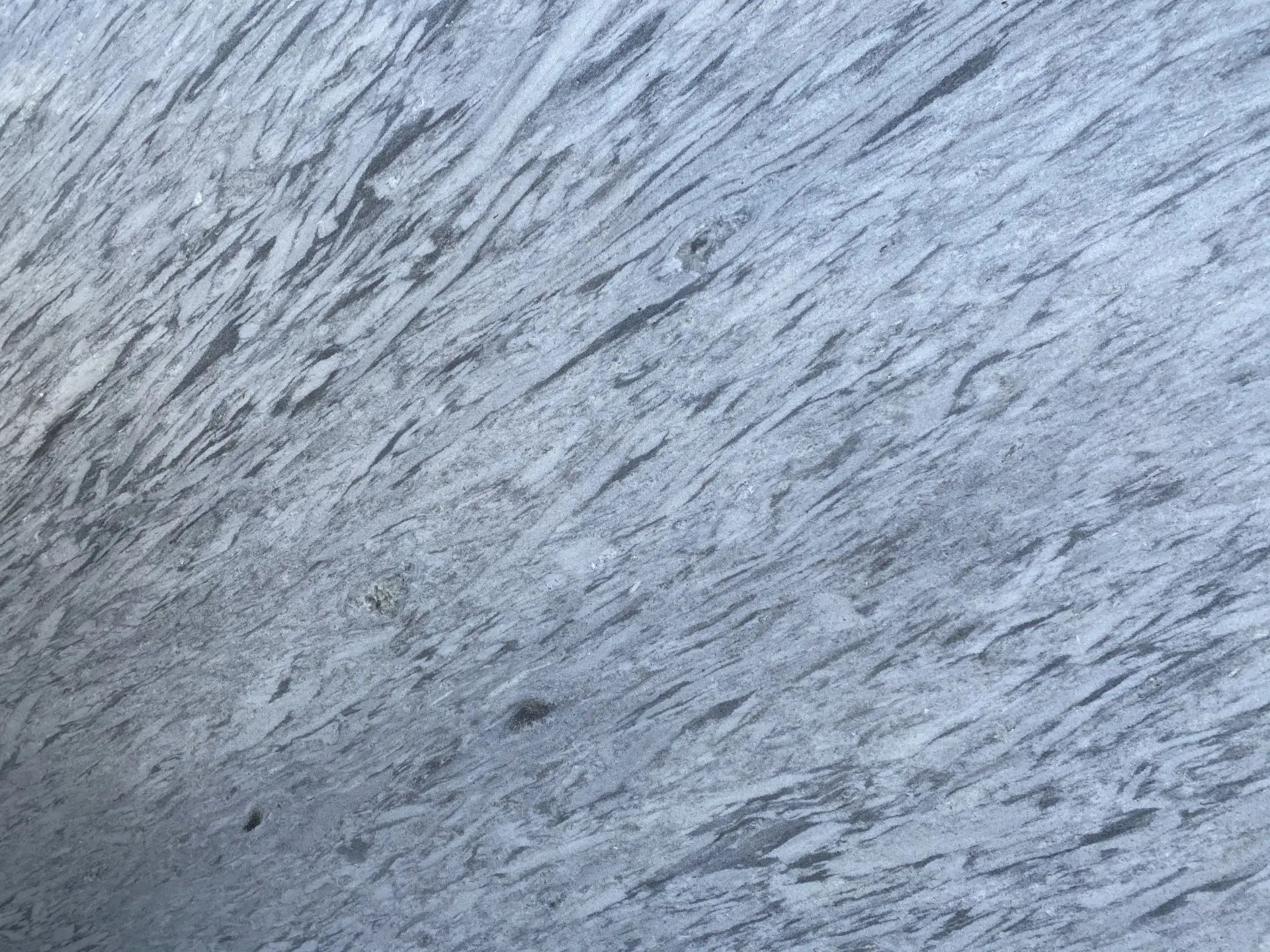 Close-up of gray-blue textured surface with diagonal streaks