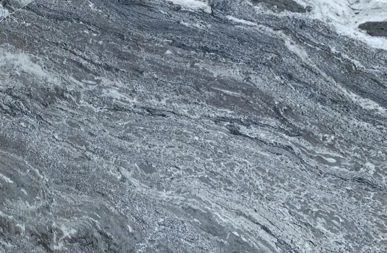 Gray and white marbled stone texture with flowing veins and diagonal streaks