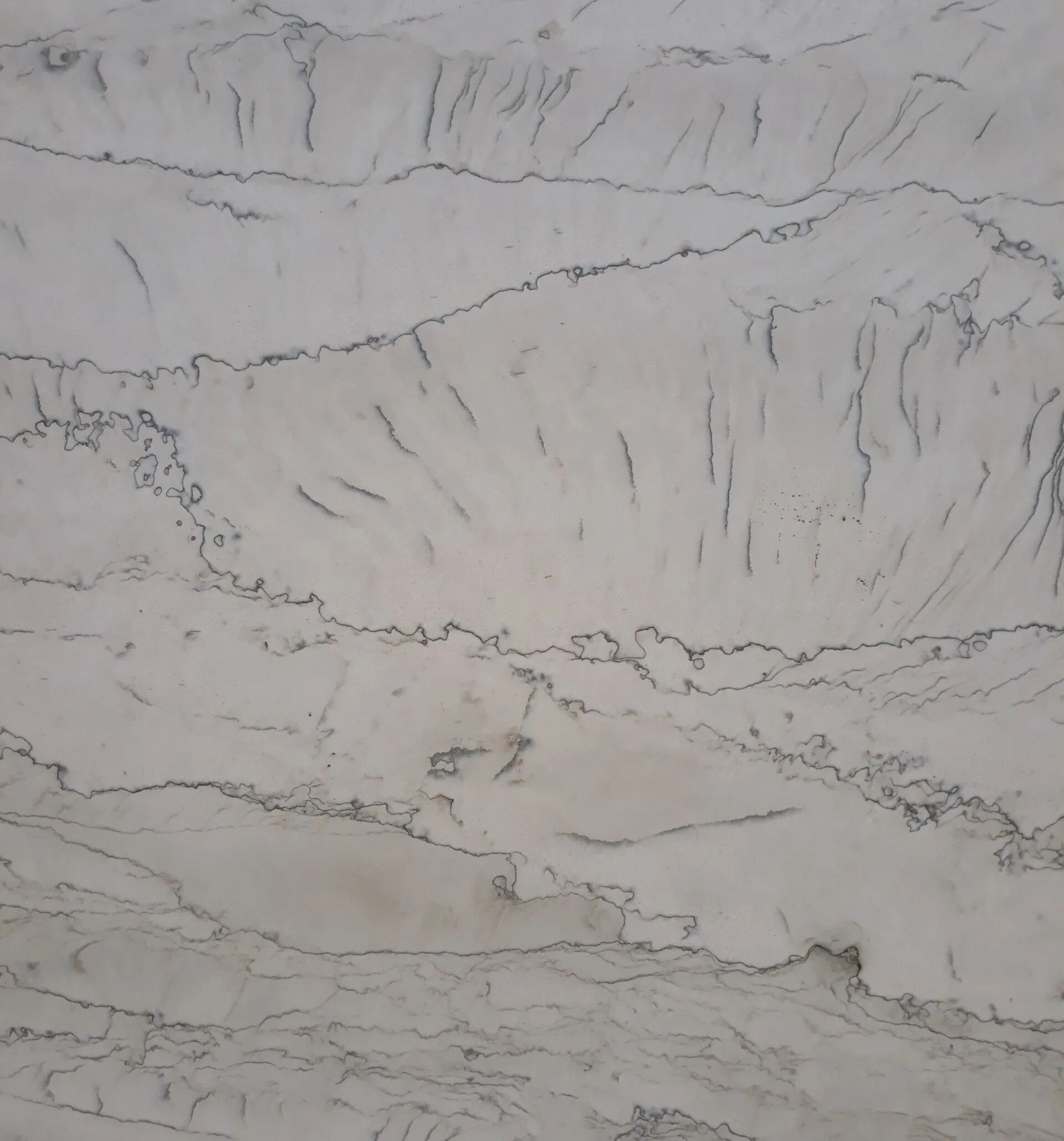 Gray marble-like stone surface with subtle veining and layered texture