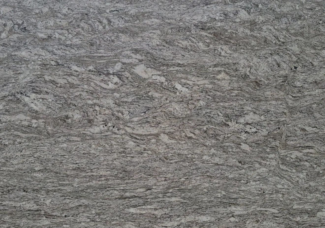 Gray speckled stone or concrete surface with a rough, textured pattern