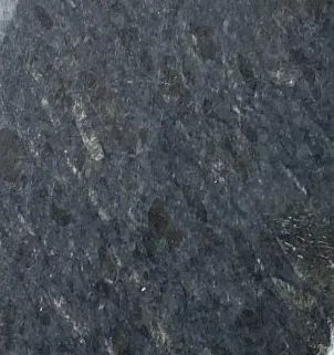 Dark gray textured surface with a few small white specks