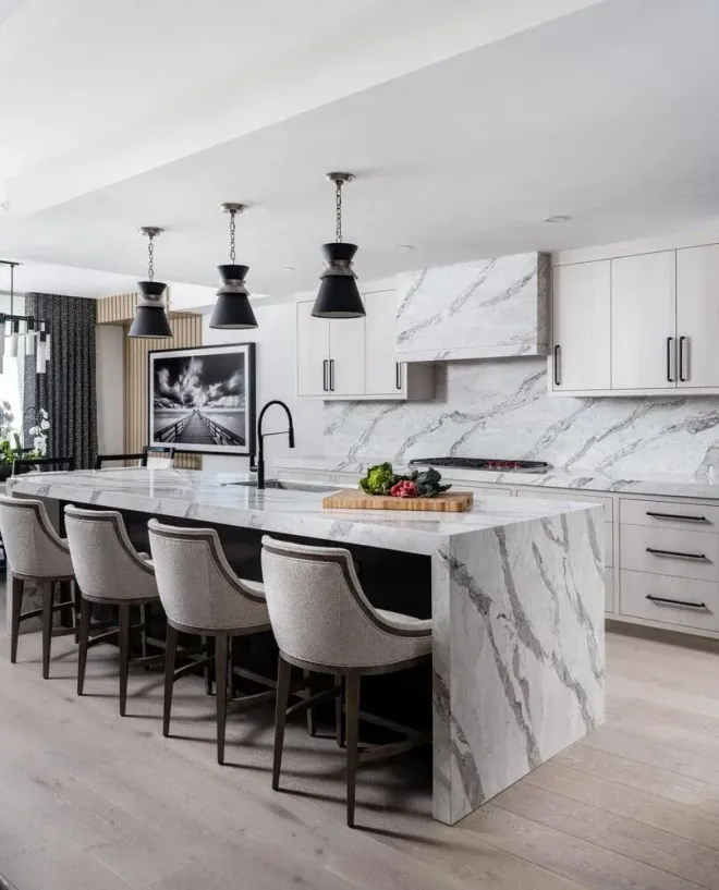 Bright kitchen with granite countertop, stainless sink, and window above the counter